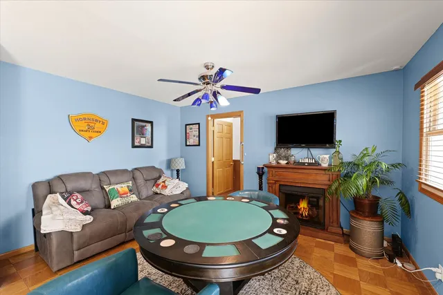 a living room with furniture a window and a flat screen tv