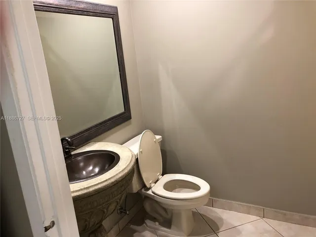 a white toilet sitting next to a sink