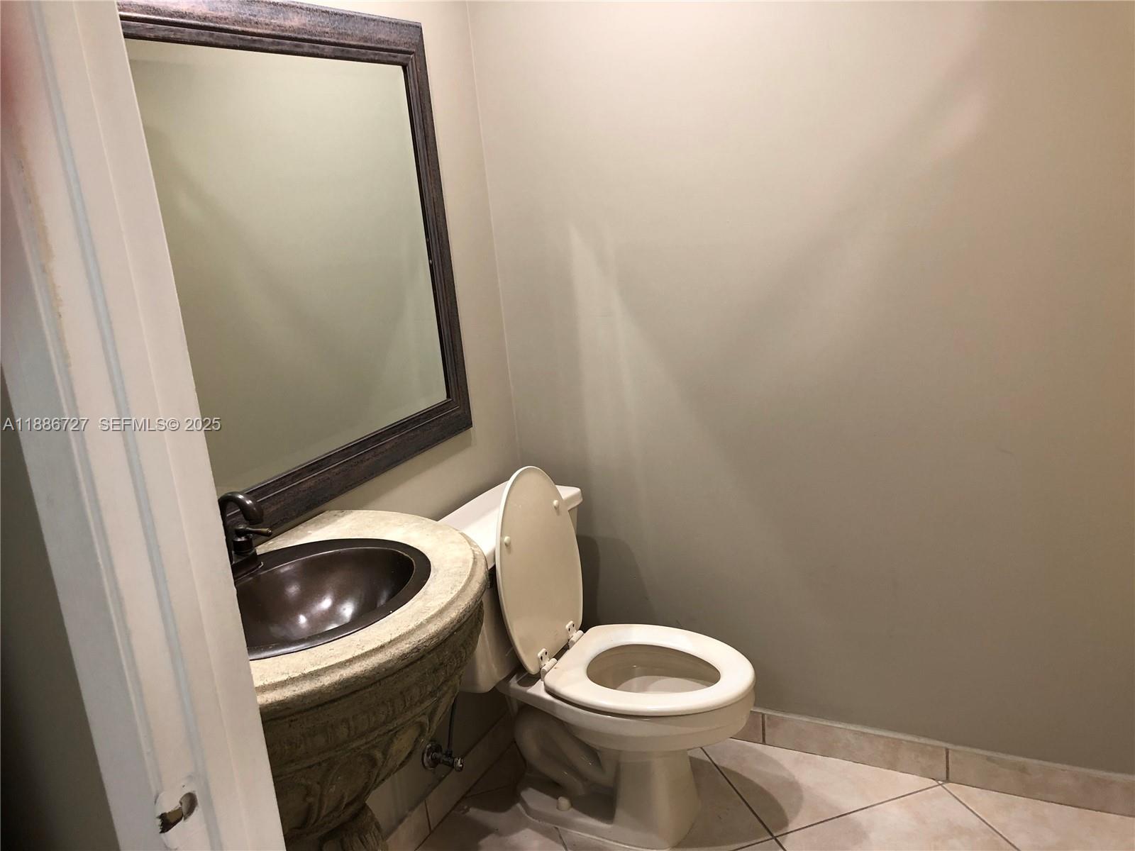 15875 Southwest 3rd Street, Unit 101 Pembroke Pines, FL 33027 - Photo 16 of 32 a white toilet sitting next to a sink