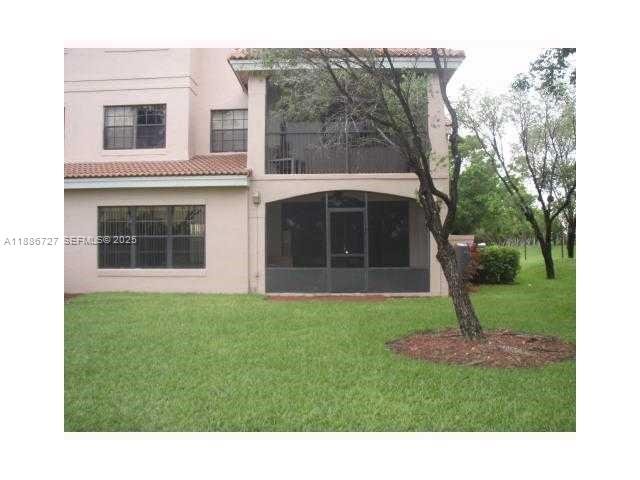 15875 Southwest 3rd Street, Unit 101 Pembroke Pines, FL 33027 - Photo 17 of 32 a black and white house with a yard