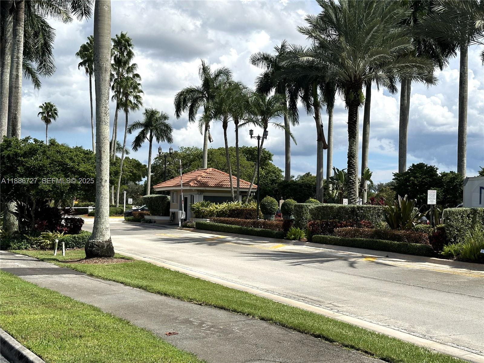 15875 Southwest 3rd Street, Unit 101 Pembroke Pines, FL 33027 - Photo 19 of 32 a front view of multiple houses with yard