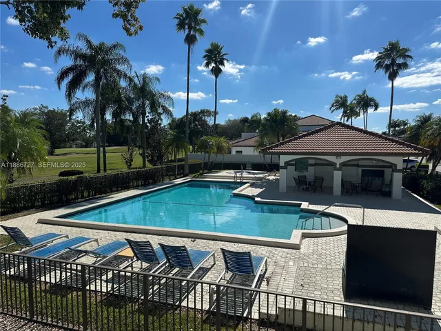 a view of a patio with swimming pool table and chairs