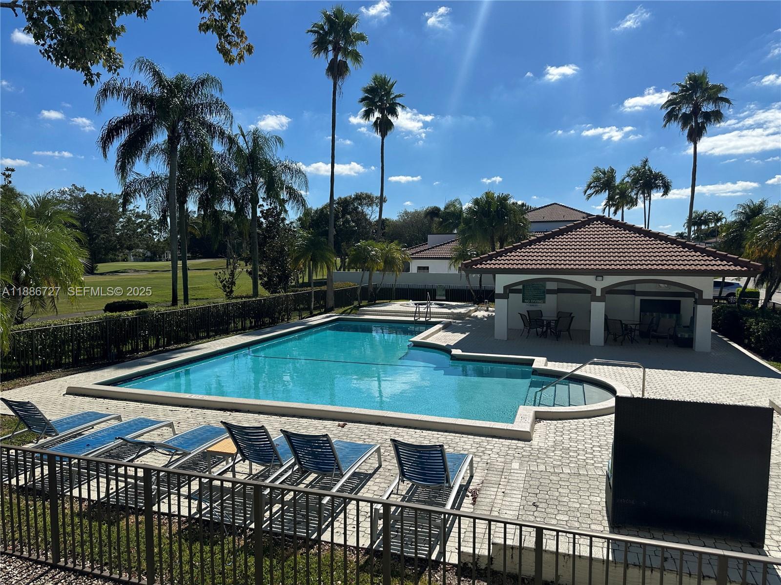 15875 Southwest 3rd Street, Unit 101 Pembroke Pines, FL 33027 - Photo 20 of 32 a view of a patio with swimming pool table and chairs