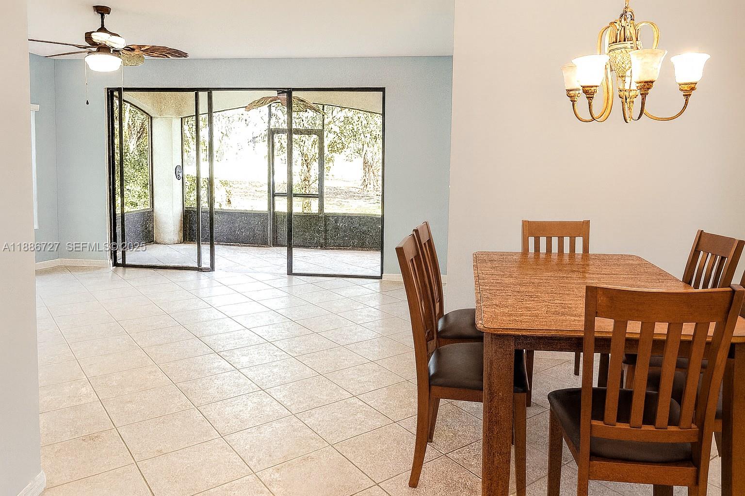 15875 Southwest 3rd Street, Unit 101 Pembroke Pines, FL 33027 - Photo 2 of 32 a view of a dining room with furniture window and outside view