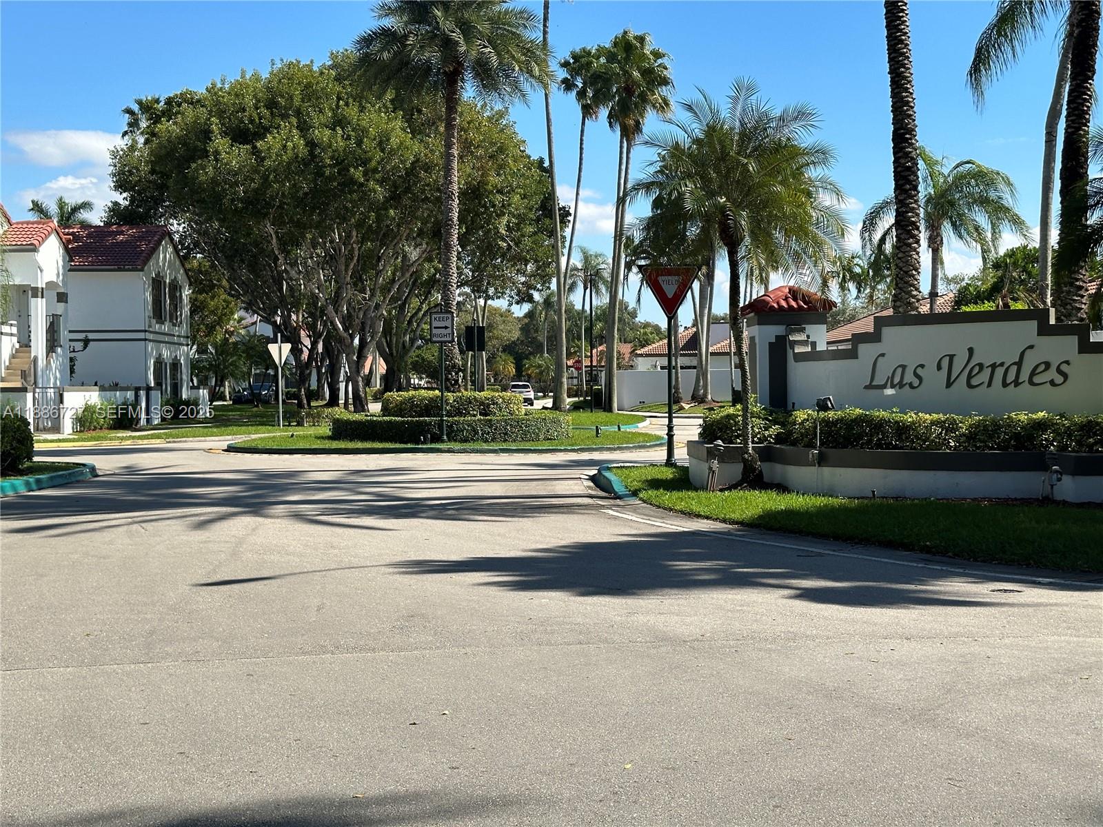 15875 Southwest 3rd Street, Unit 101 Pembroke Pines, FL 33027 - Photo 29 of 32 a front view of multi story residential apartment building with yard and green space