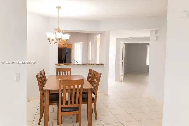 a view of a dining room with furniture and chandelier