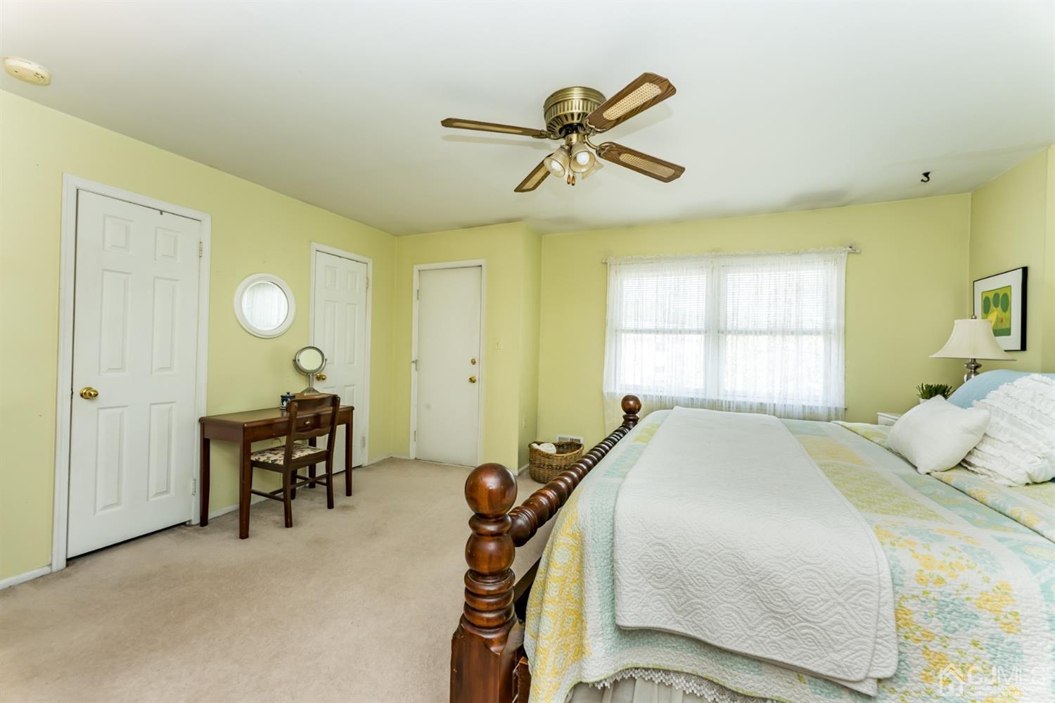 917 Robin Road Hillsborough, NJ 08844 - Photo 14 of 26 a bedroom with a bed and a chandelier