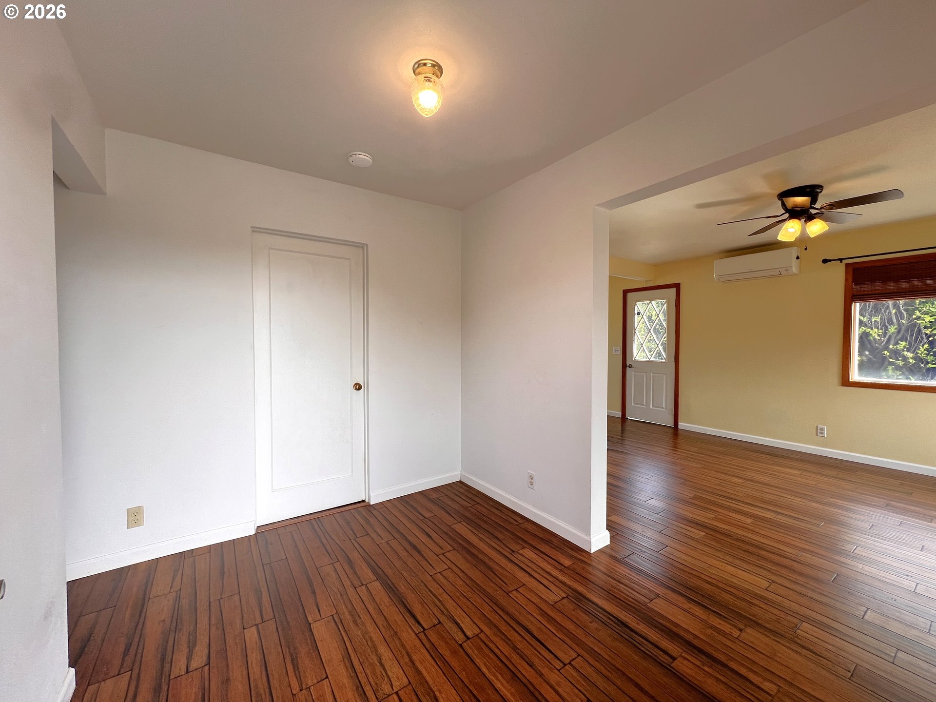 1092 Lewis Street North Bend, OR 97459 - Photo 17 of 43 a view of an empty room with wooden floor and a window