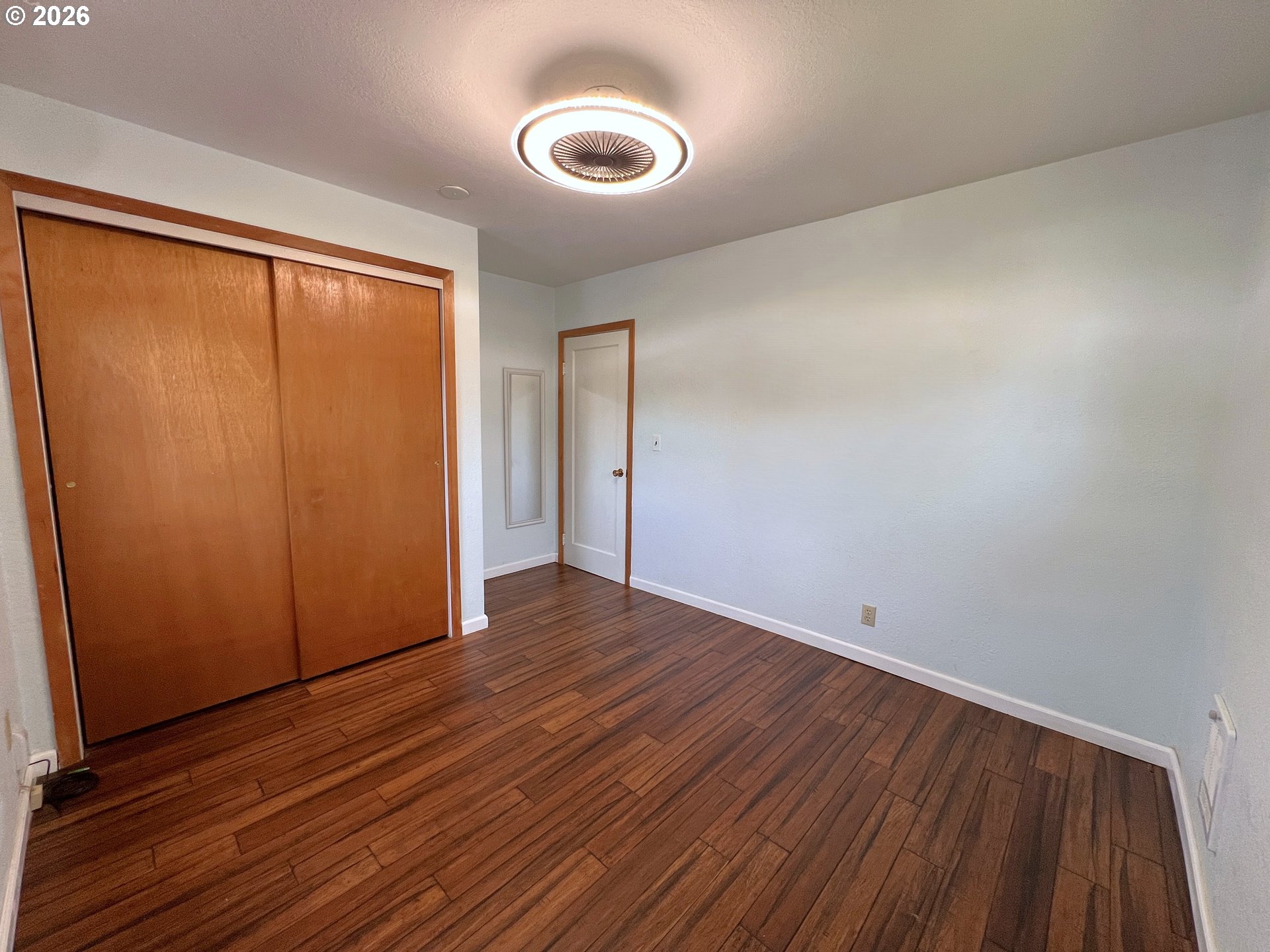 1092 Lewis Street North Bend, OR 97459 - Photo 19 of 43 a view of an empty room with wooden floor and a window