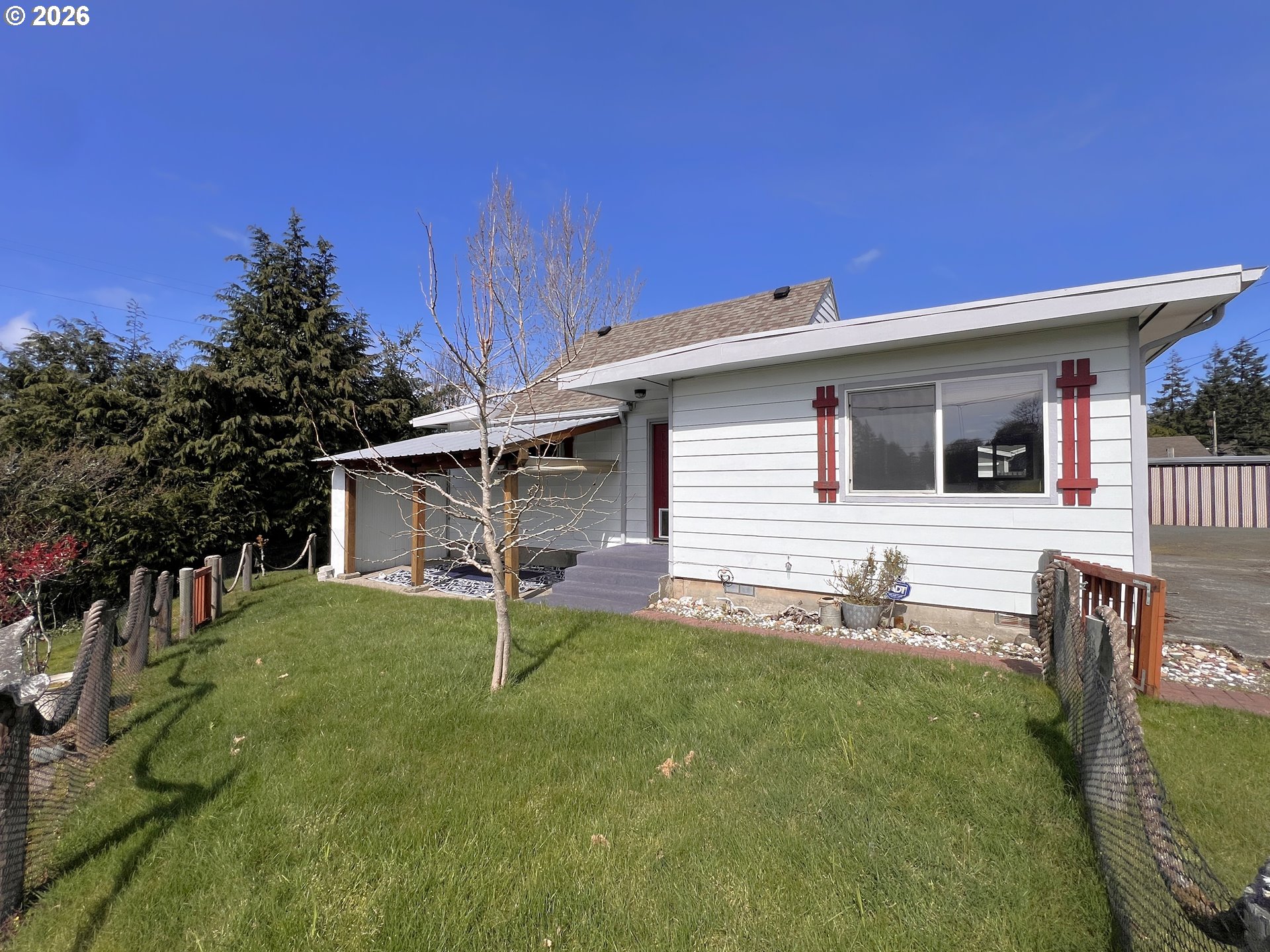 1092 Lewis Street North Bend, OR 97459 - Photo 2 of 43 a backyard of a house with table and chairs