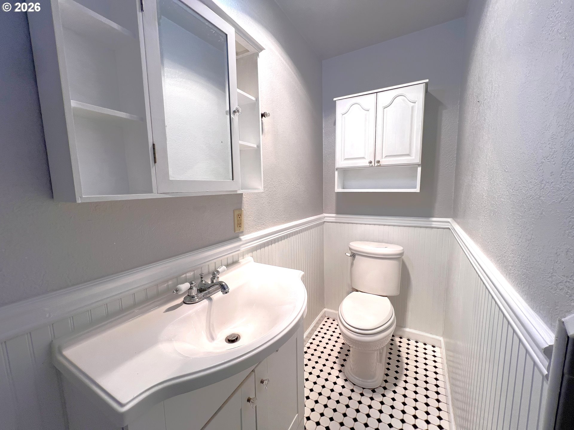 1092 Lewis Street North Bend, OR 97459 - Photo 21 of 43 a bathroom with a sink a toilet a mirror and shower