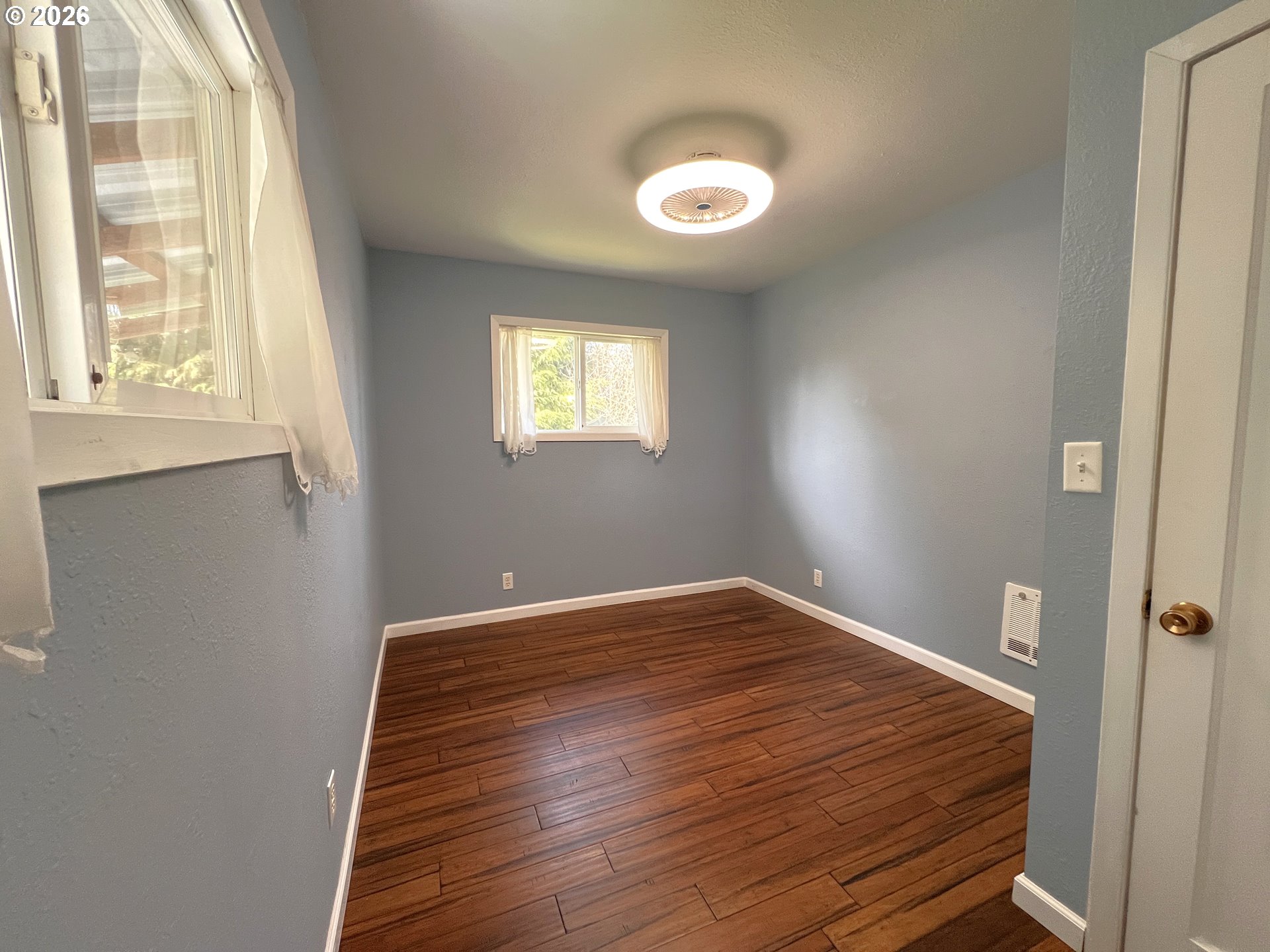 1092 Lewis Street North Bend, OR 97459 - Photo 24 of 43 a view of empty room with wooden floor and fan