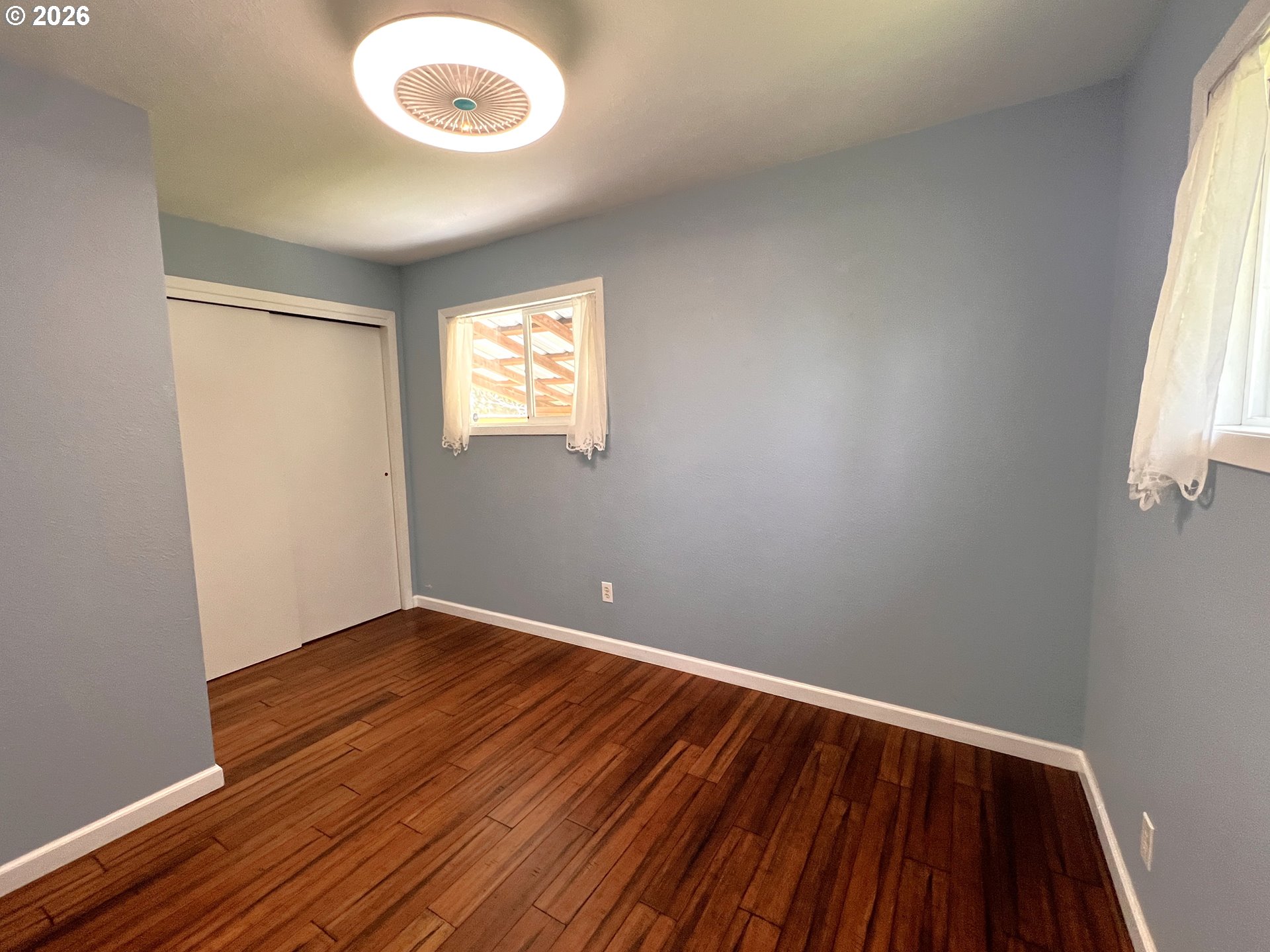 1092 Lewis Street North Bend, OR 97459 - Photo 25 of 43 an empty room with wooden floor and windows