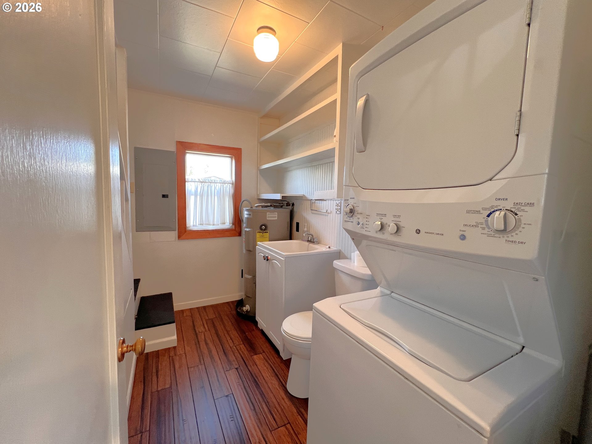 1092 Lewis Street North Bend, OR 97459 - Photo 26 of 43 a view of washer and dryer with wooden floor
