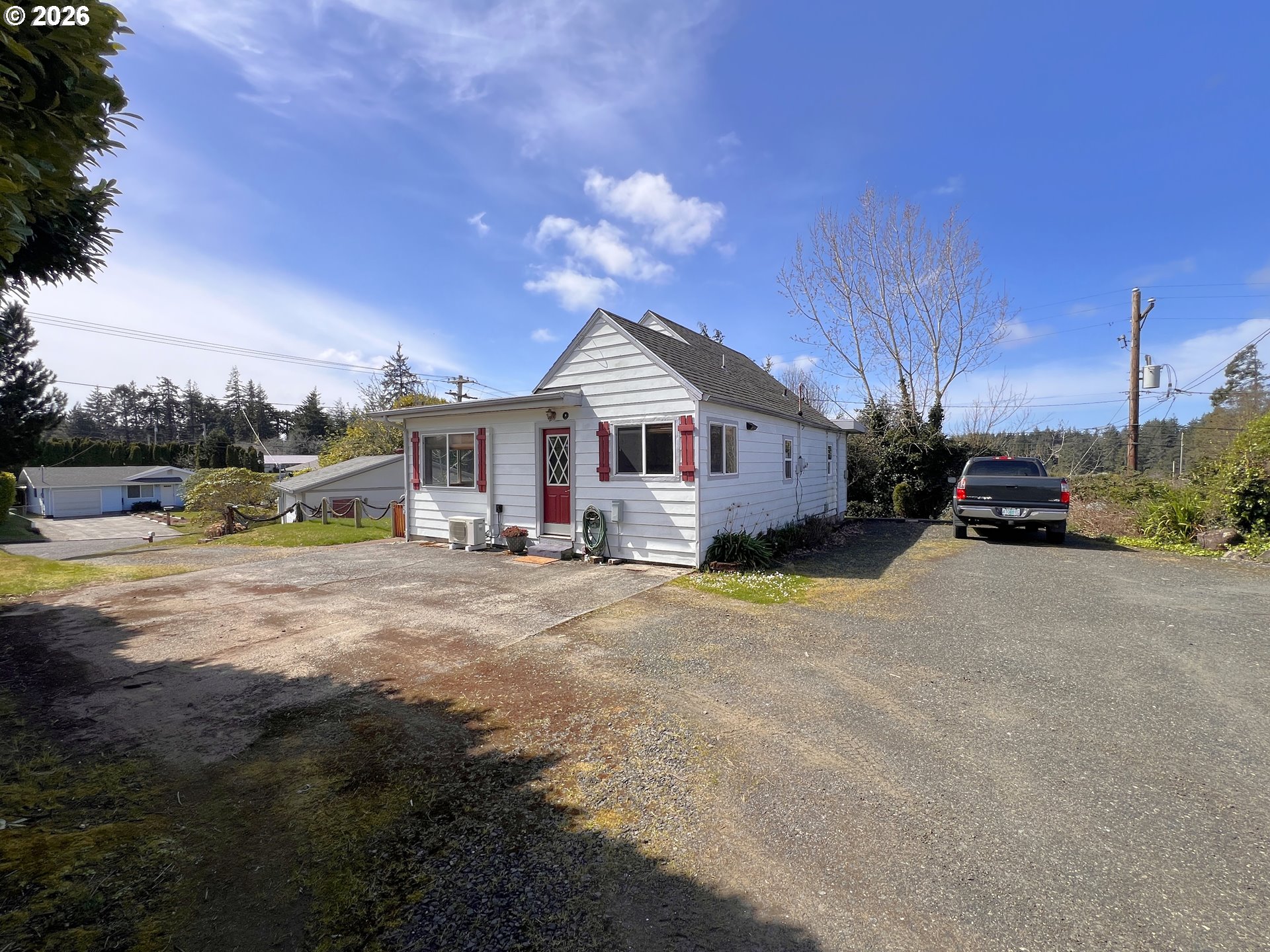 1092 Lewis Street North Bend, OR 97459 - Photo 30 of 43 a front view of a house with a garden and yard