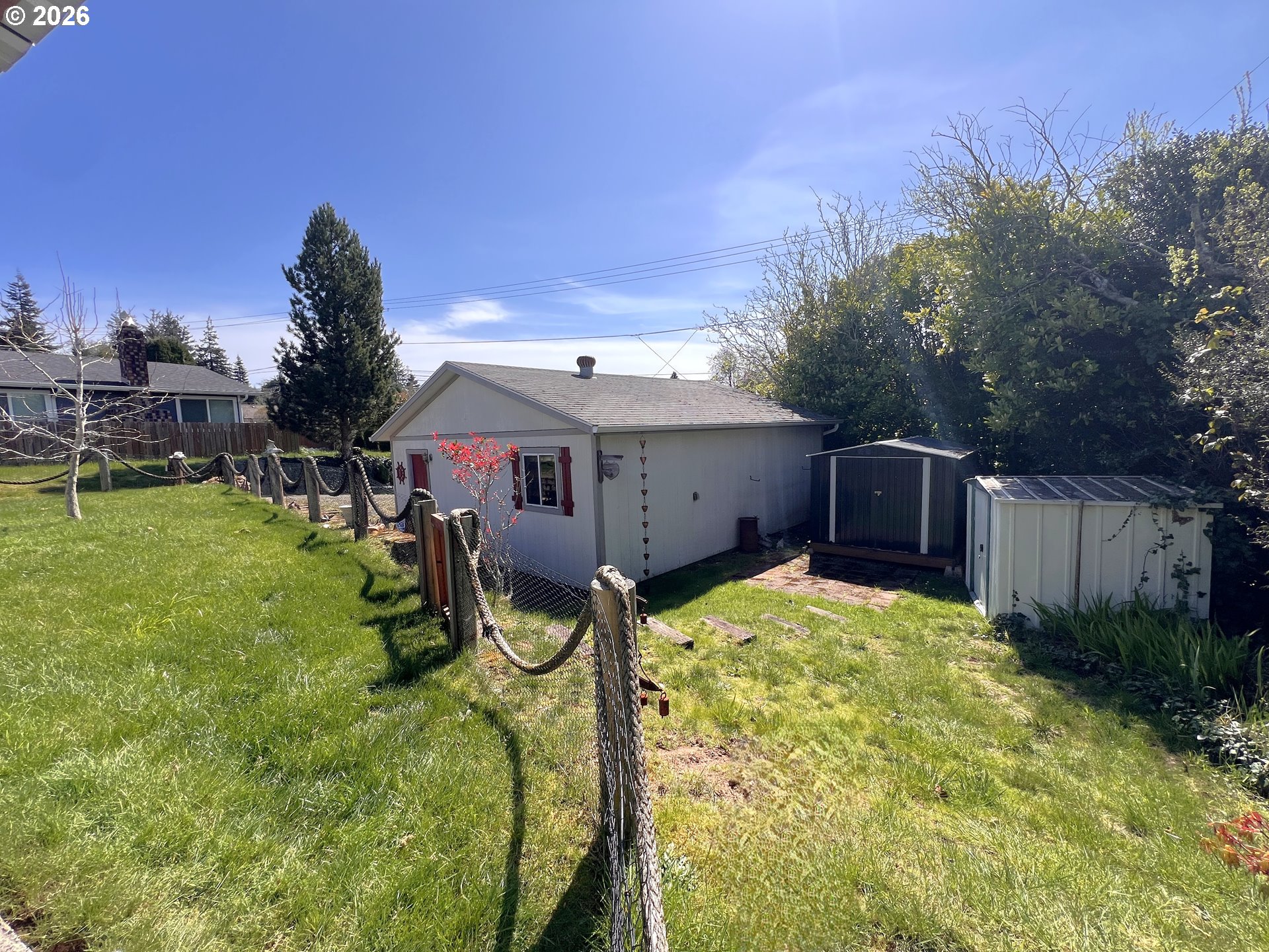 1092 Lewis Street North Bend, OR 97459 - Photo 38 of 43 a view of a house with backyard and a tree