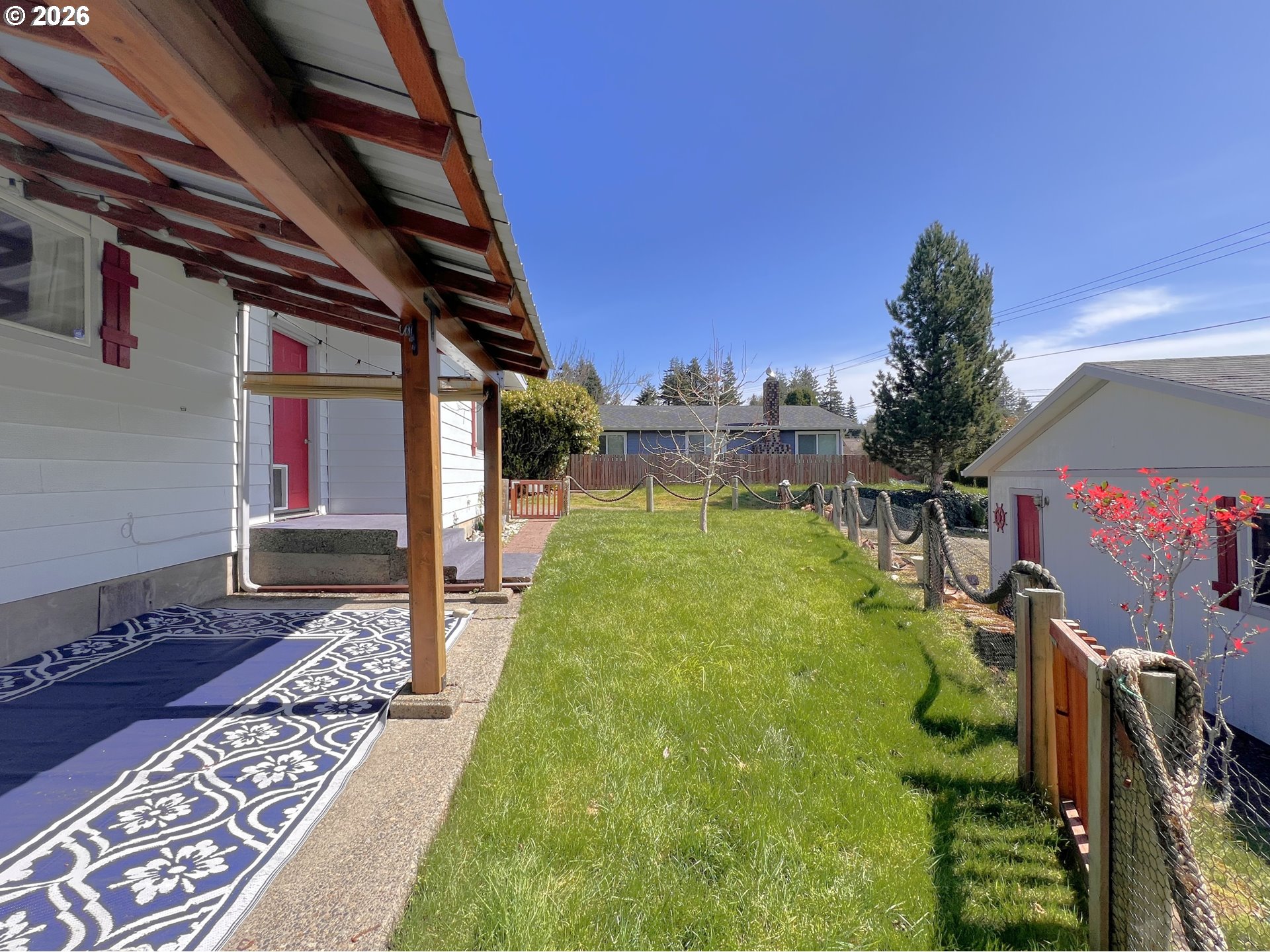 1092 Lewis Street North Bend, OR 97459 - Photo 4 of 43 a backyard of a house with table and chairs