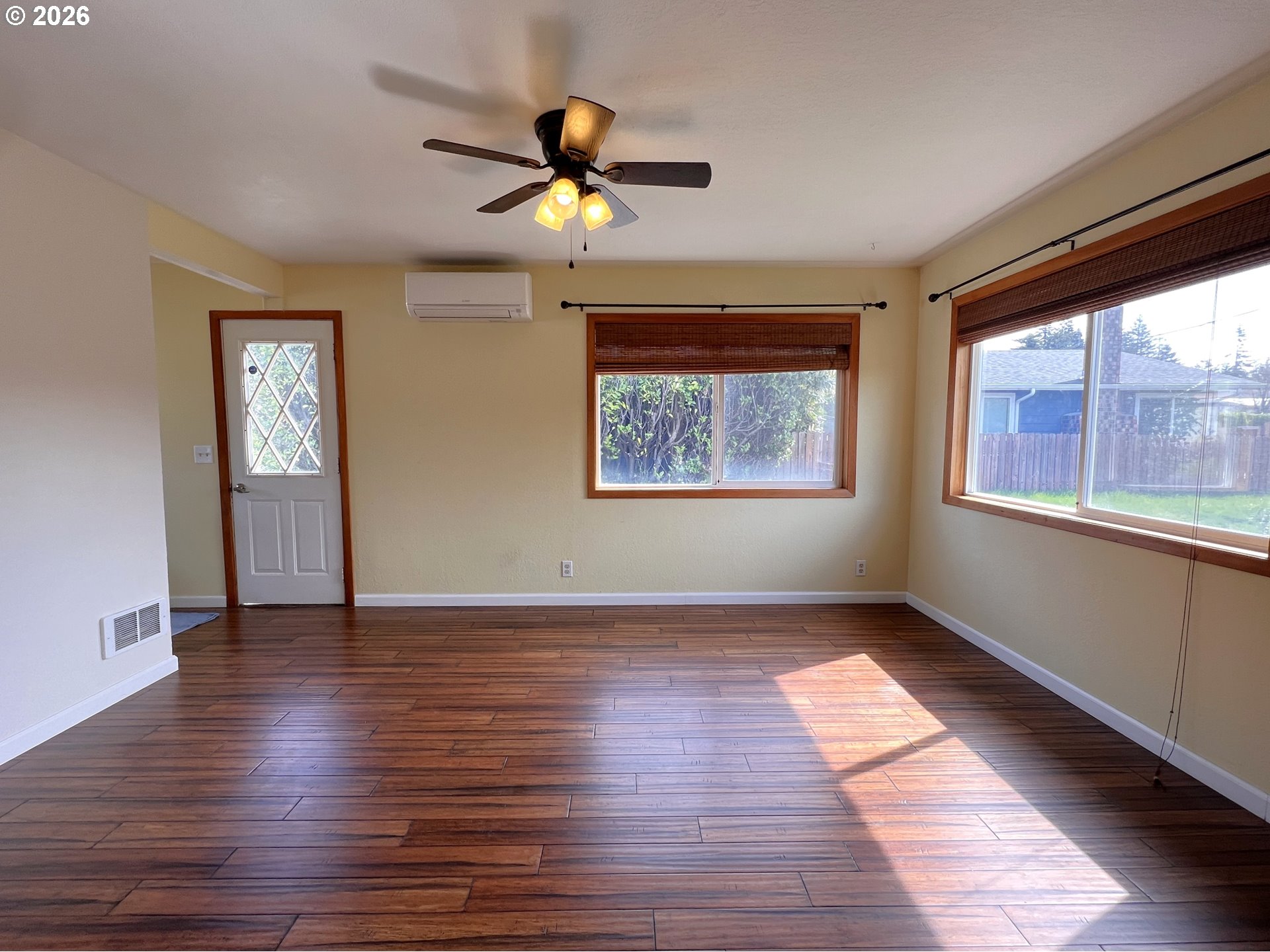 1092 Lewis Street North Bend, OR 97459 - Photo 6 of 43 a view of an empty room with wooden floor and a window