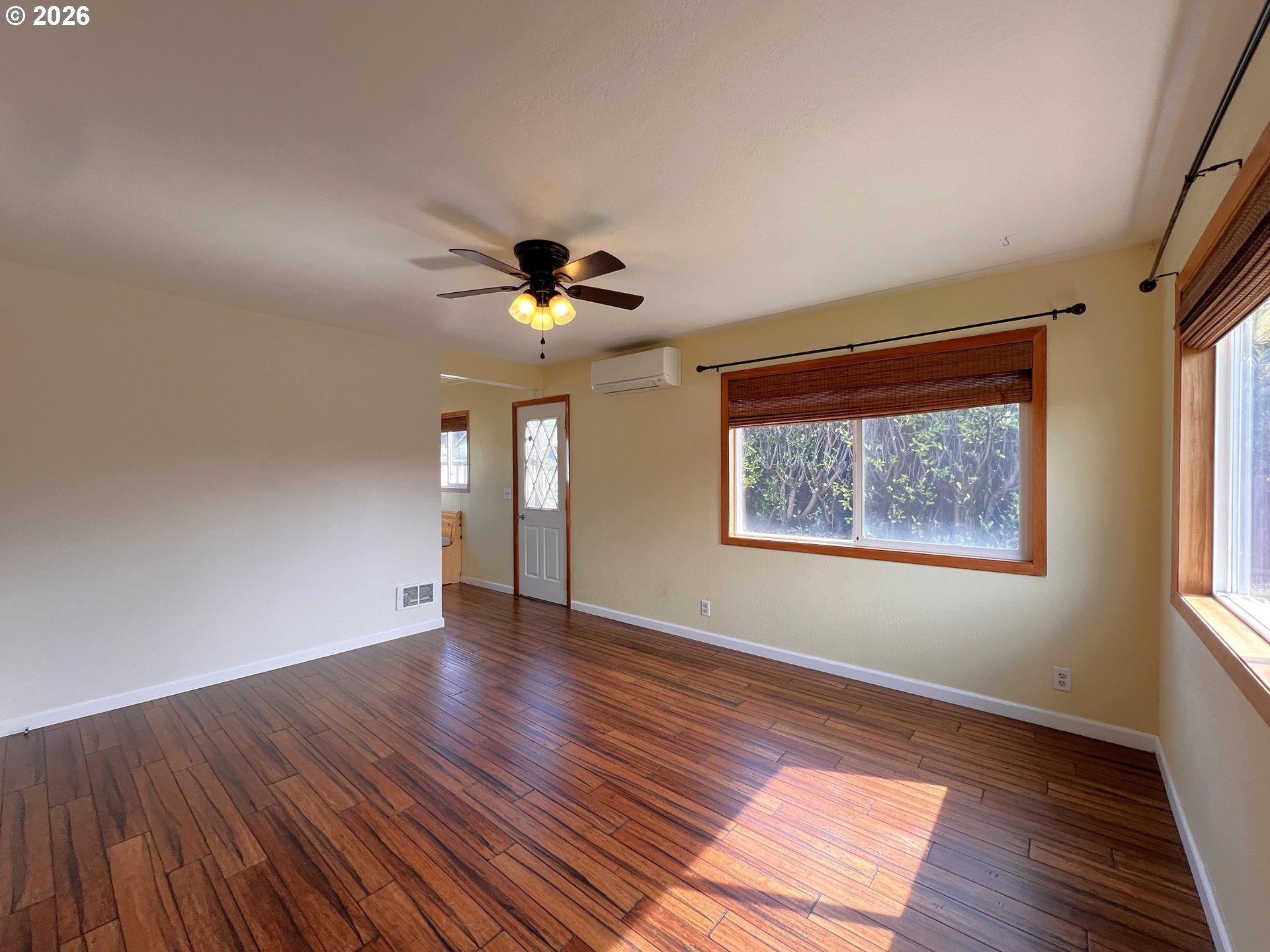 1092 Lewis Street North Bend, OR 97459 - Photo 7 of 43 a view of an empty room with wooden floor and a window