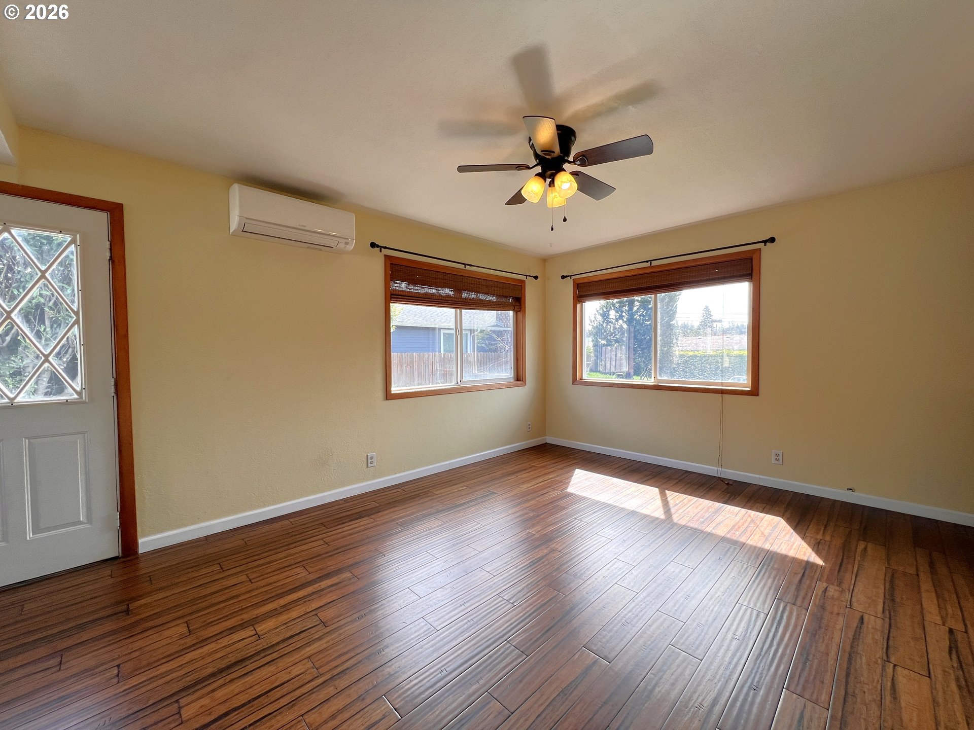 1092 Lewis Street North Bend, OR 97459 - Photo 8 of 43 a view of an empty room with wooden floor and a window