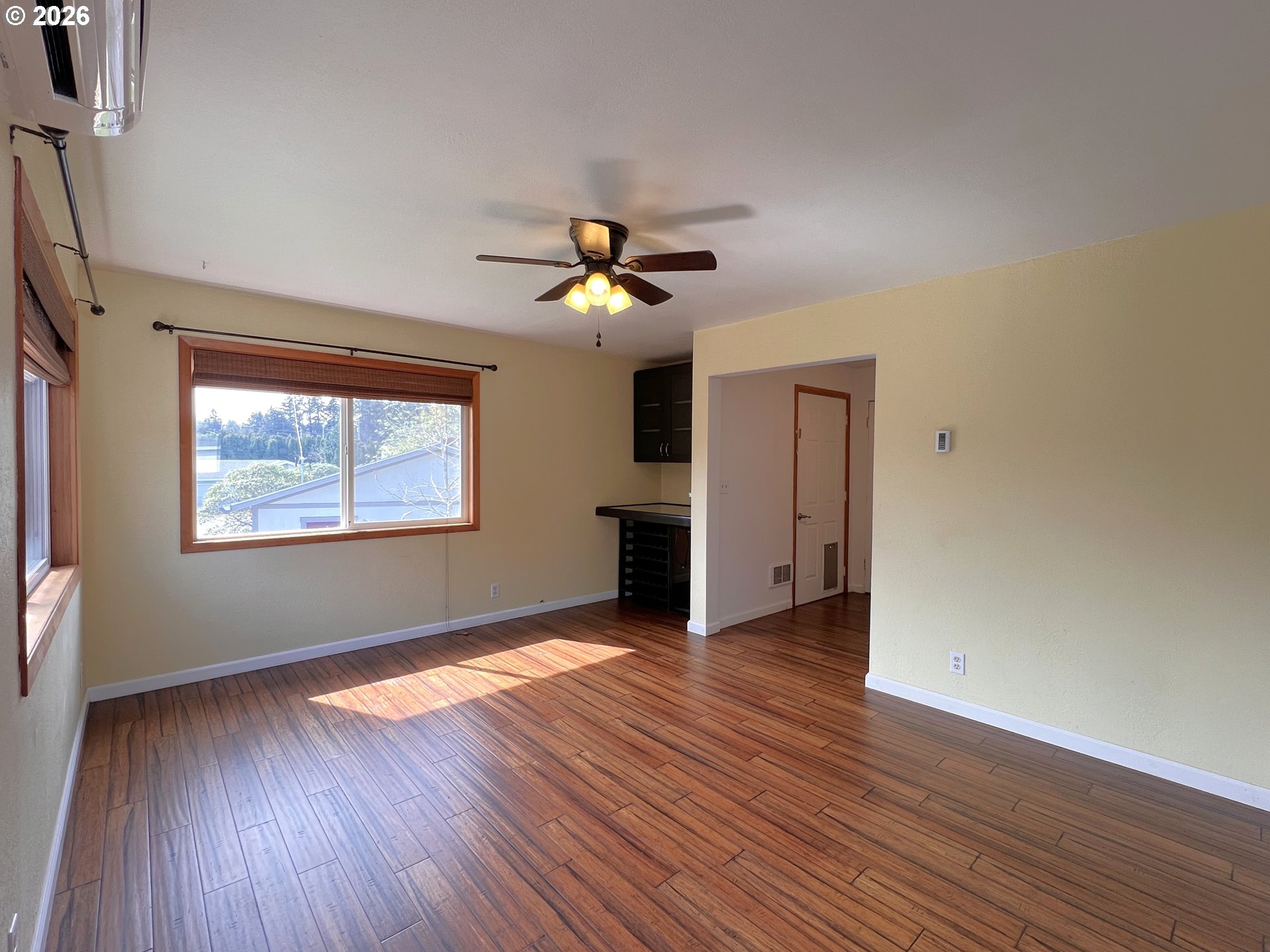 1092 Lewis Street North Bend, OR 97459 - Photo 9 of 43 a view of an empty room with wooden floor and a window