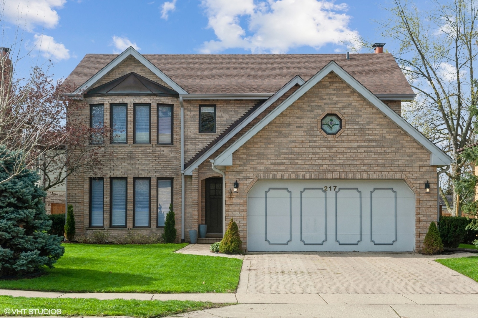 a front view of a house with a garden