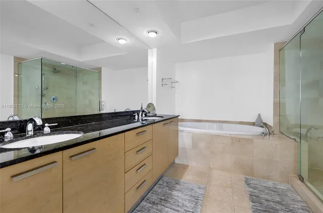a bathroom with a double vanity sink and a mirror