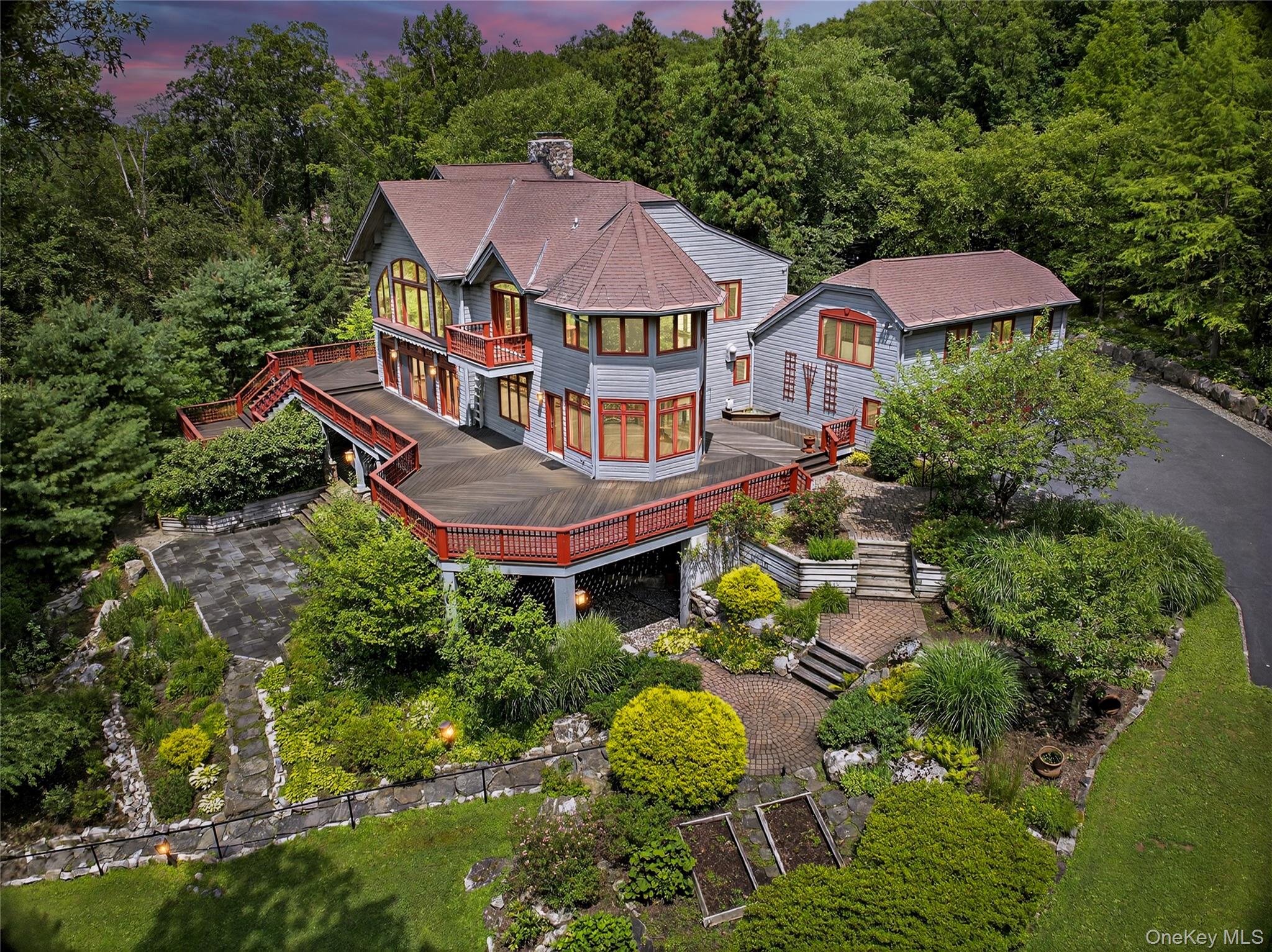 an aerial view of a house with swimming pool and trees