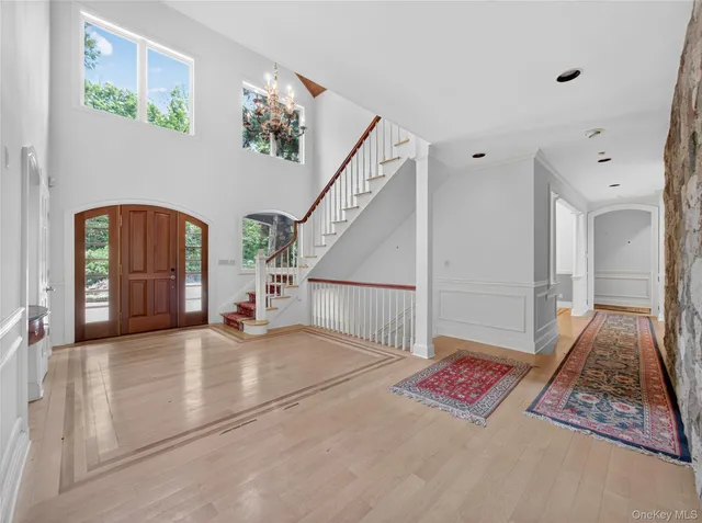 a view of a hallway with windows and stairs