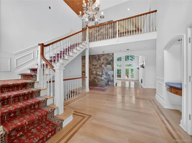 a view of an entryway wooden floor and a living room