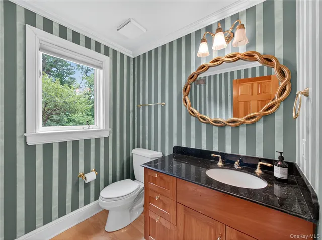 a bathroom with a sink a toilet and a mirror