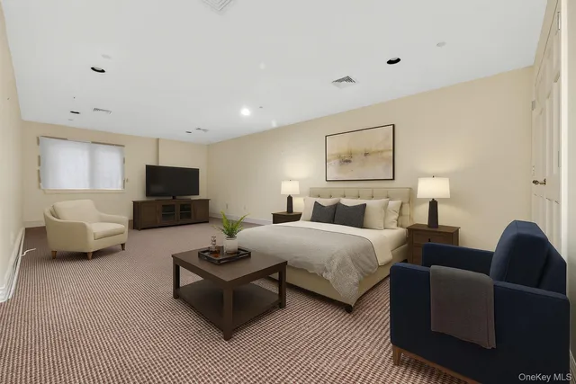 a living room with furniture a couch and a flat screen tv