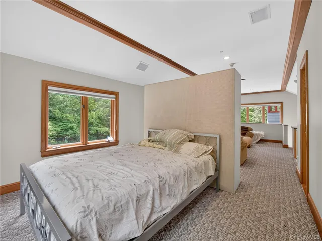 a spacious bedroom with a bed and a large window