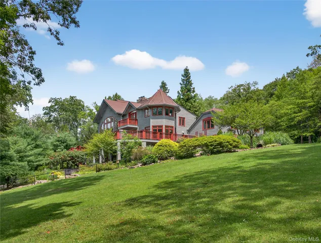 a aerial view of a house with a big yard and potted plants