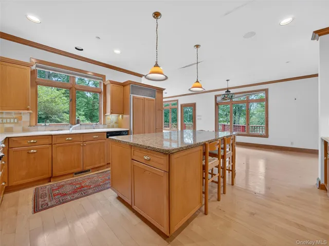 a kitchen with stainless steel appliances granite countertop a stove and a wooden floors