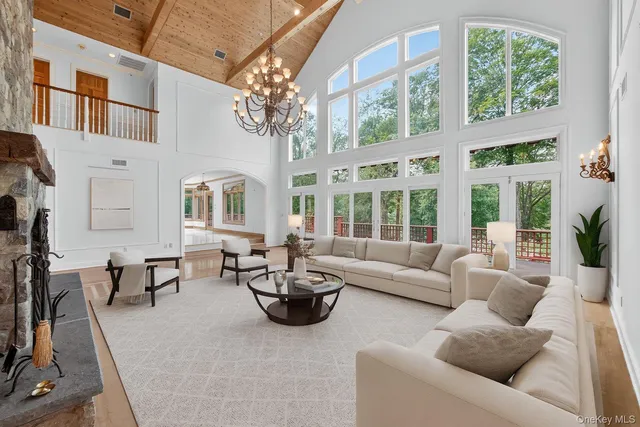 a living room with furniture and a chandelier