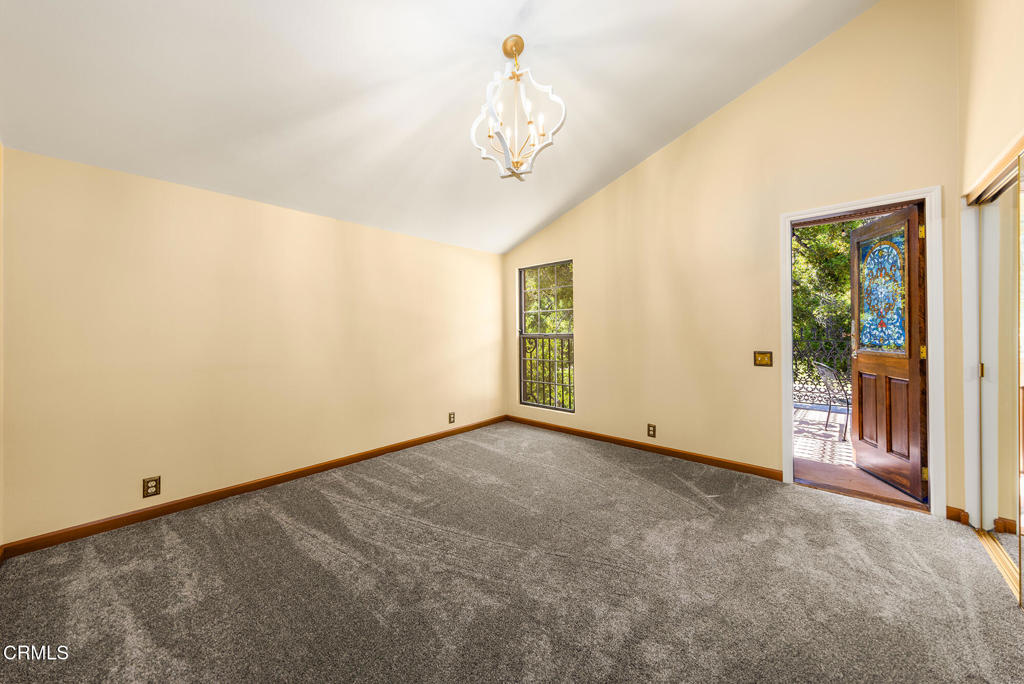 10484 Creek Road Oak View, CA 93022 - Photo 18 of 52 a view of a hallway with a chandelier fan and windows