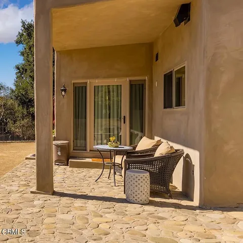 a table and chair sitting in front of a building