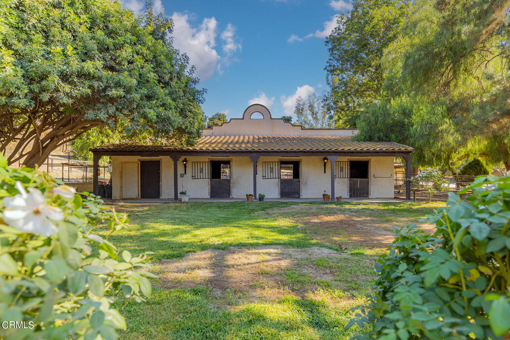 10484 Creek Road Oak View, CA 93022 - Photo 39 of 52 a front view of a house with a garden and trees