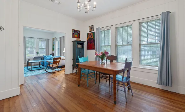 a view of a dining room with furniture window and wooden floor