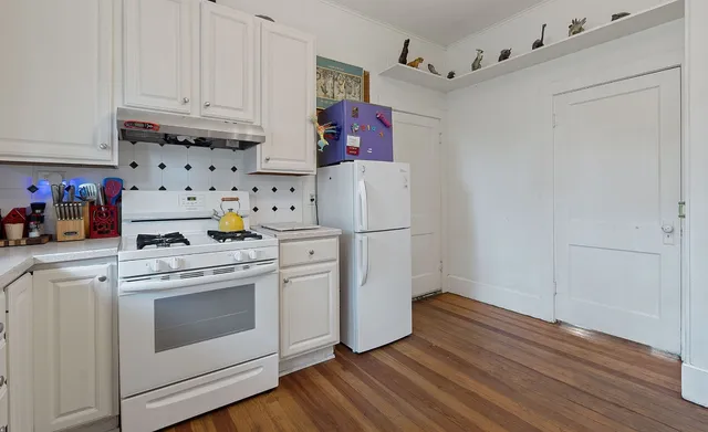 a kitchen with appliances a stove and a refrigerator