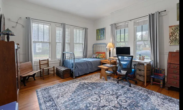a view of a livingroom with workspace and a window