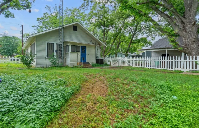 a front view of a house with yard and green space