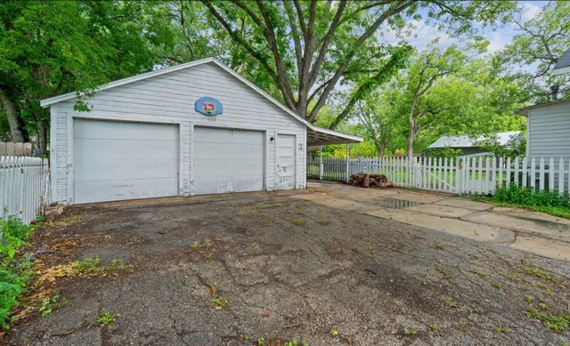 a view of a house with a backyard and tree
