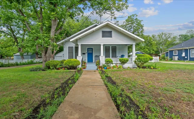 a front view of a house with yard and green space