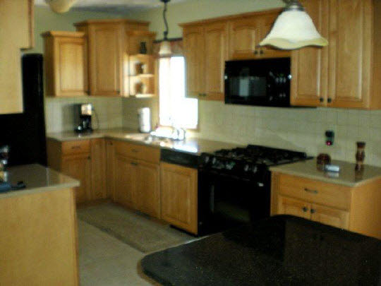 1711 East Currier Road Freeport, IL 61032 - Photo 5 of 8 a kitchen with a sink a stove and cabinets