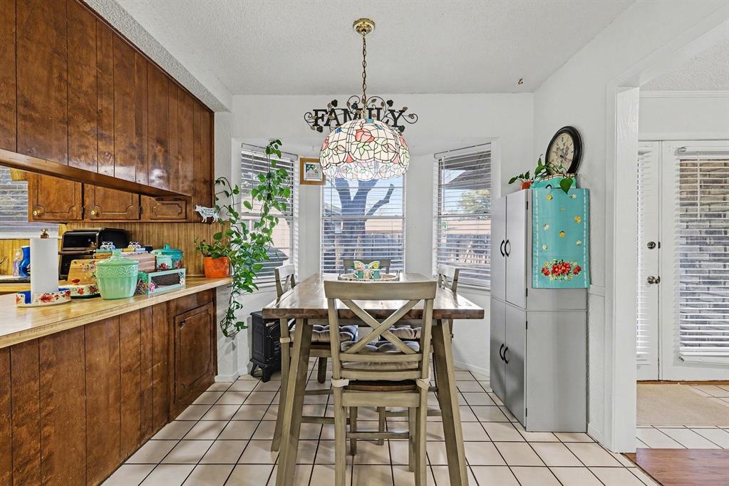6013 Robin Drive Watauga, TX 76148 - Photo 16 of 30 Dining room featuring a textured ceiling and light tile patterned floors
