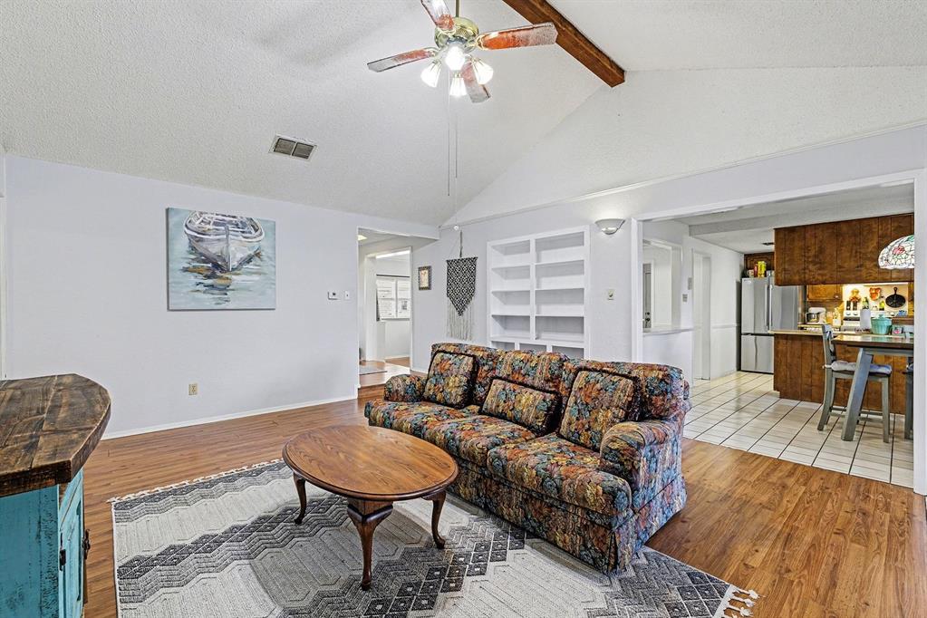 6013 Robin Drive Watauga, TX 76148 - Photo 20 of 30 Living area with light wood-style flooring, ceiling fan, a textured ceiling, and built in features