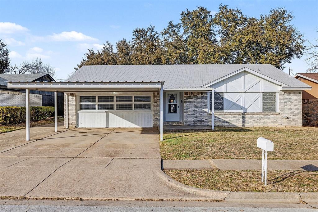 6013 Robin Drive Watauga, TX 76148 - Photo 2 of 30 Ranch-style house featuring driveway, a front yard, and brick siding