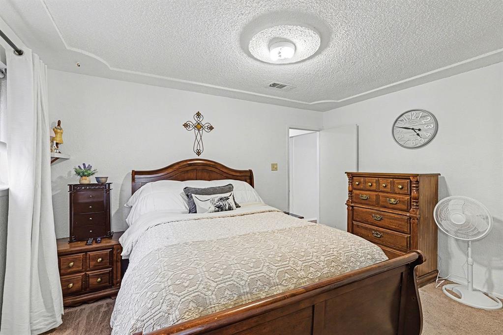 6013 Robin Drive Watauga, TX 76148 - Photo 22 of 30 Carpeted bedroom featuring a textured ceiling
